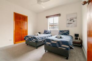 a bedroom with two beds and a window at Joshi's Villa in Seymour