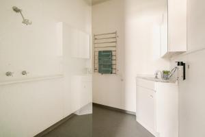 a bathroom with white cabinets and a sink at Joshi's Villa in Seymour +39 photos