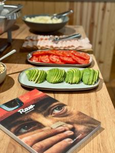a table with two plates of food and a magazine at Basecamps Cerdanya in Caixáns +52 photos