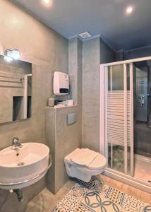 a bathroom with a sink and a toilet at Melina Hotel - Central in Polygryos +24 photos