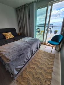 a bedroom with a bed and a view of the ocean at Villa with a view in Ålesund