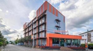 a building with an orange and blue facade on a street at Belleville hotel in Phetchabun