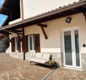a couch sitting on a patio outside of a house at Oasi Lake Iseo in Solto Collina