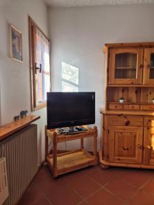 a flat screen tv sitting on a table in a room at Il Posticino del Lago di Como in Esino Lario