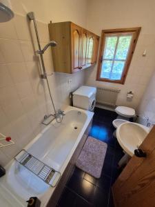 a bathroom with a tub and a toilet and a sink at Il Posticino del Lago di Como in Esino Lario +20 photos