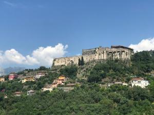 a castle on top of a hill with houses at Borgo Carla in Massa