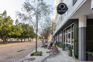 a group of people standing outside of a building at ONOMO Hotel Foreshore in Cape Town