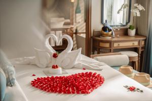 a bed with a heart made out of red roses at Bhaya Soul - Wellness Inclusive Cruise in Ha Long +38 photos