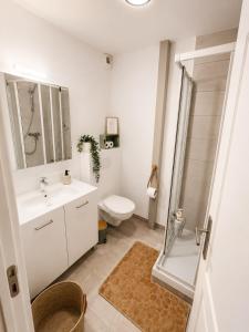 a bathroom with a toilet and a sink and a shower at Ribeirinha Guesthouse in Guarda +16 photos