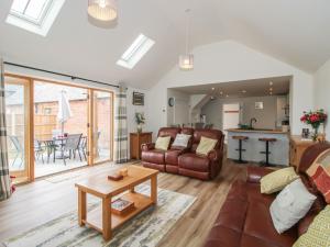 a living room with a couch and a table at Chestnut Barn in Shrewsbury