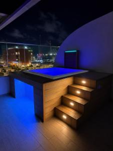 a bar on the roof of a building at night at Elevate View Penthouse in Santo Domingo