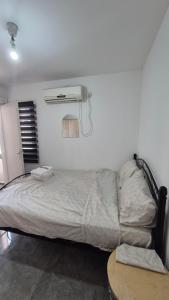 a bedroom with a bed with a fan and a table at Sinai st in Eilat