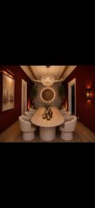 a room with a table and chairs and a chandelier at Sekeria Hammam & Suites, Historic Mansion Hotel in Heraklio