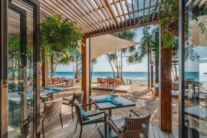 a restaurant with a view of the beach at Pimalai Resort & Spa in Ko Lanta