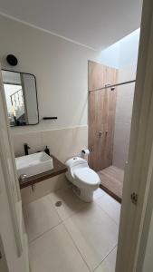 a bathroom with a toilet and a sink and a shower at Casa Almara - Ica in Ica