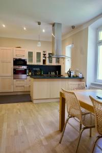a kitchen with a table and chairs and a stove at Apartment Vilém in Janske Lazne