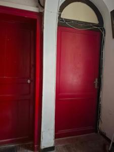 two red doors next to each other in a room at Studio en toute simplicité plein centre in Libourne