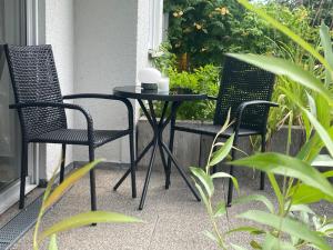 two chairs and a small table on a balcony at Apartment Alex in Pirna