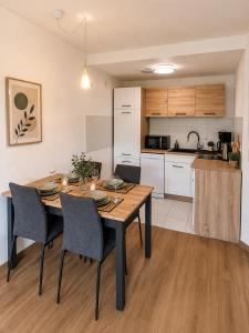 a kitchen and dining room with a table and chairs at Apartment Alex in Pirna