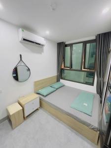 a small bedroom with a bed and a window at Tuệ Tĩnh Hotel in Hải Dương