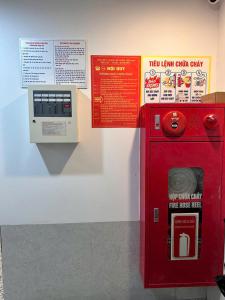 a red machine is next to a wall at Tuệ Tĩnh Hotel in Hải Dương