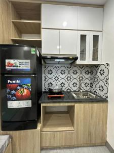 a kitchen with a counter with a stove top oven at Tuệ Tĩnh Hotel in Hải Dương +2 photos