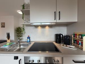 a kitchen with a sink and a counter top at Wohnglück Leer City Nr 3 in Leer +3 photos