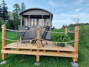 a gazebo with a table and a laptop on it at Schäferwagen Weidetraum in Naila +2 photos