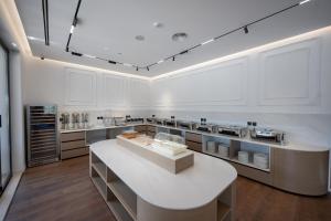 a large white kitchen with a large island in it at Hotel By Holiday in Rinas