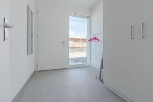 an empty room with a door and a window at Bluemlisalp Studio - Aare Jungfrau AG in Spiez