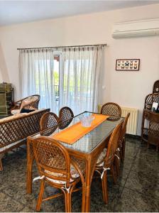 a dining room with a table and chairs at Villa Theodora 30m from the beach in Egira