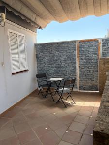 a table and two chairs on a patio at Apartamento turístico ilusiones 5 in Cazalla de la Sierra