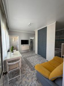 a bedroom with a bed and a desk and a television at Apartamento turístico ilusiones 5 in Cazalla de la Sierra