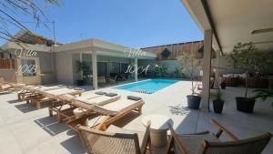 a patio with a table and chairs and a swimming pool at Elysian Residences Heraklion in Heraklio