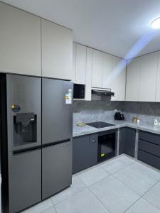 a kitchen with stainless steel appliances and gray cabinets at Casa Almara - Ica in Ica