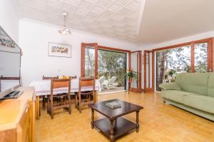 a living room with a couch and a table at Es Jaç in Cala Santanyi