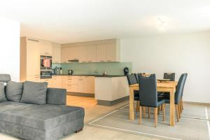 a living room with a couch and a table at Moench Apartment - Aare Jungfrau AG in Wilderswil +1 photo