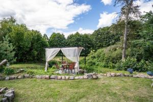 a gazebo with a table and chairs in a yard at Tipi Jurte Zelt in der Seenplatte in Carpin +24 photos