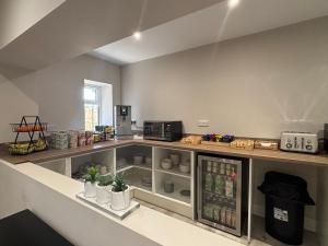 a kitchen with a refrigerator filled with drinks at East Halton Hotel in East Halton