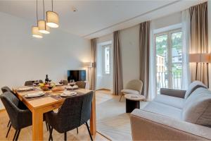 a living room with a dining room table and a couch at Residenza Tilia in San Bernardino