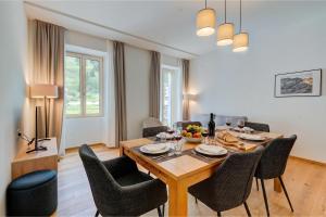 a dining room with a wooden table and chairs at Residenza Tilia in San Bernardino