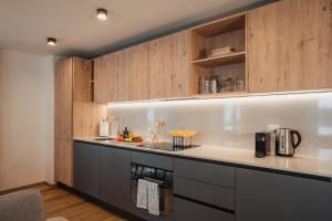 a kitchen with wooden cabinets and a counter top at Residenza Tilia in San Bernardino