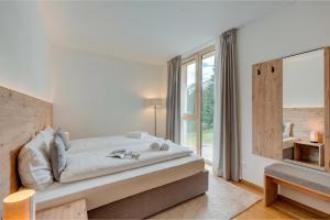 a bedroom with a bed and a large window at Residenza Tilia in San Bernardino +64 photos