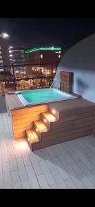 a swimming pool on a rooftop at night at Elevate View Penthouse in Santo Domingo