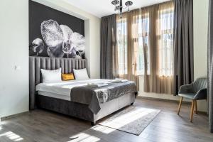 a bedroom with a bed and a large window at Corner House in Lovech
