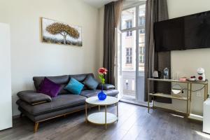 a living room with a couch and a tv at Corner House in Lovech
