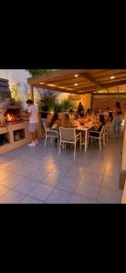 a group of people sitting at a table in a restaurant at Celina in Bastia
