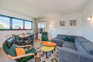 a living room with a couch and a table at Lindenstraße Ferienwohnung Anker in Koserow