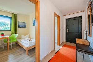 a room with a bed and a table and a window at Lindenstraße Ferienwohnung Anker in Koserow