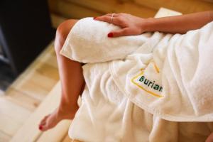 a woman with a towel on her back at Buriani-resort in Tsʼkhvarichamia